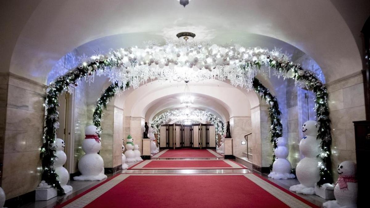 The Lower Cross Hall of the White House is decorated with “snowball” arches created from more than 6,000 ornaments and snowmen lining the corridor for Christmas in 2016.