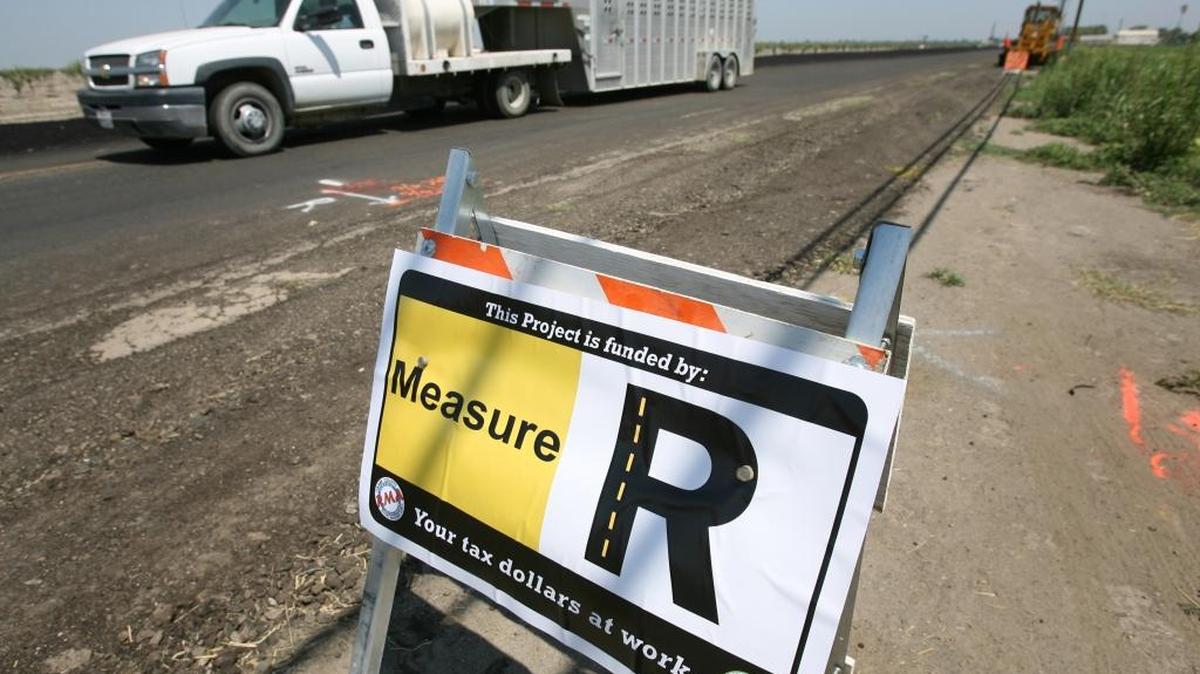 A sign near Tulare informs motorists that the road work is being funded by Measure R --  a half-cent sales tax passed by voters ikn 2014.