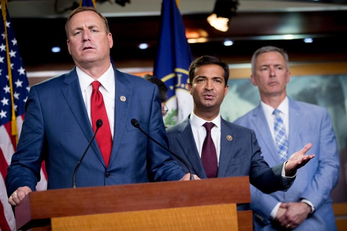 Rep. Jeff Denham, R-Calif., left, and Rep. Carlos Curbelo, R-Fla., second from left, accompanied by Rep. John Katko, R-N.Y., right, respond to a reporters question during a news conference on Capitol Hill in Washington, Wednesday, June 27, 2018.