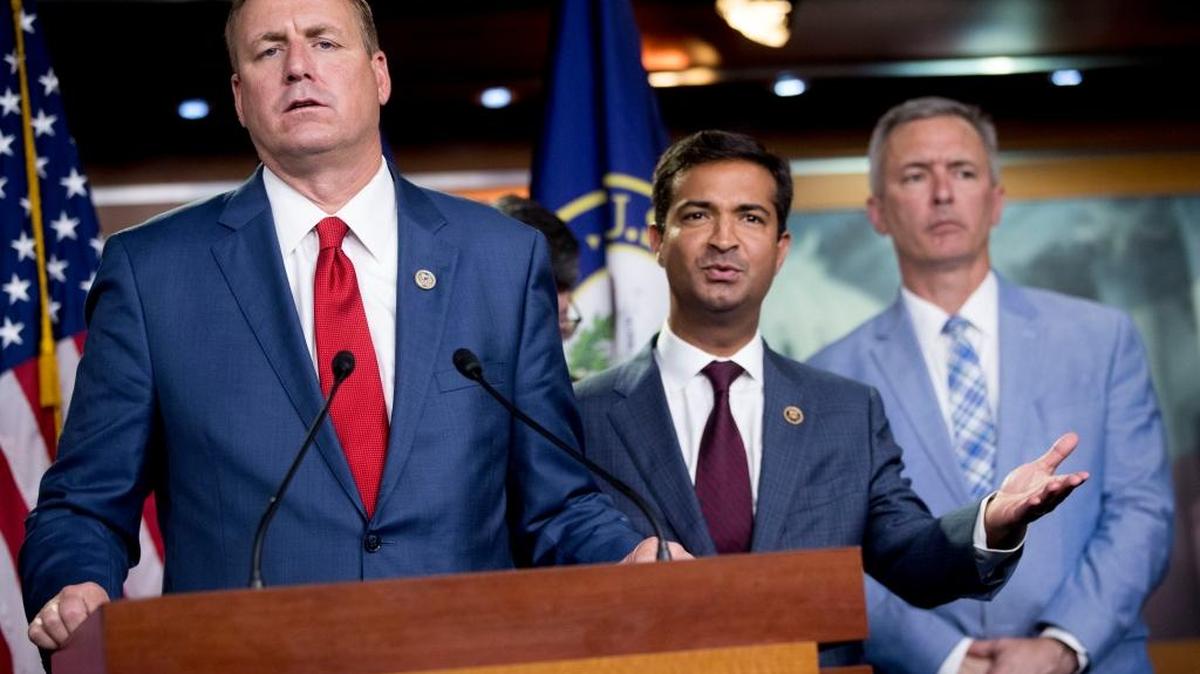 Rep. Jeff Denham, R-Calif., left, and Rep. Carlos Curbelo, R-Fla., second from left, accompanied by Rep. John Katko, R-N.Y., right, respond to a reporters question during a news conference on Capitol Hill in Washington, Wednesday, June 27, 2018.