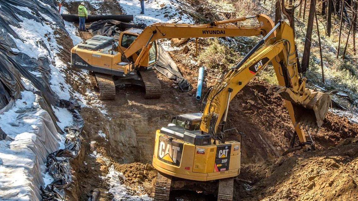 Construction crews repair state highway 120 near Yosemite last year after winter storms saturated the ground beneath and caused portions of the road to collapse. Proposition 6 would result in delays in such repairs.