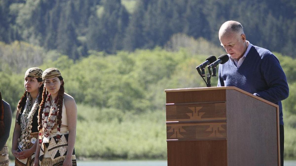 Yurok women garbed in traditional tribal ceremonial clothing stand before the mouth of the Klamath River as Gov. Jerry Brown speaks during the Klamath Hydroelectric Settlement Agreement signing ceremony on April 6 in Klamath. Endangered salmon blocked for nearly a century from hundreds of miles of the river in Oregon and California are expected to return en masse under unusual new agreements to tear down four hydroelectric dams.