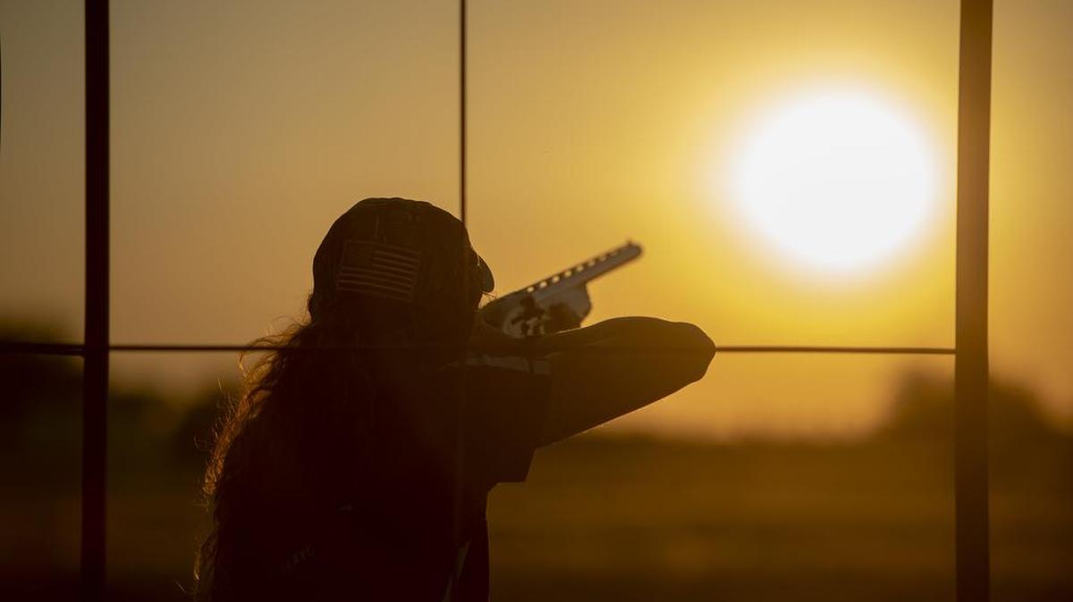 A young woman breaks a clay during a trap shooting competition near Sacramento. The Oakdale Sportsmans Club is debating its policies of excluding women from membership, though many women already use the club’s shooting ranges.