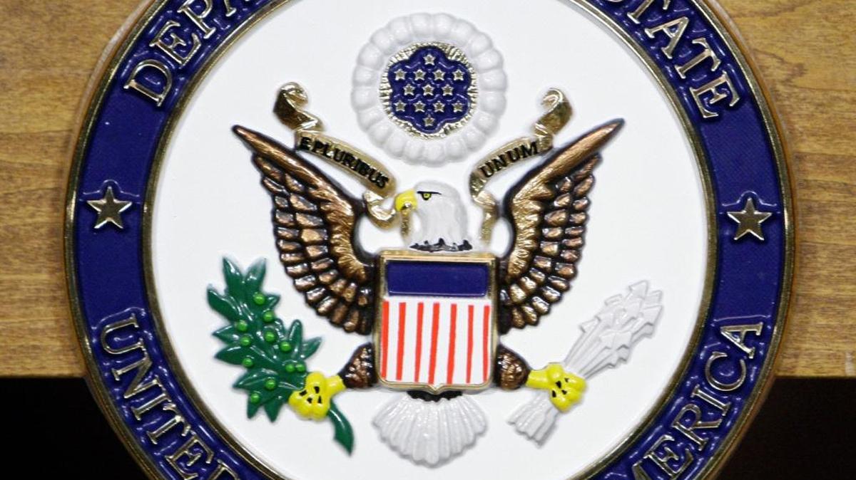 The Department of State seal on a podium at the State Department in Washington.