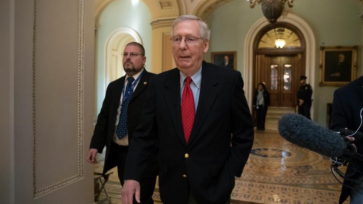 Senate Majority Leader Mitch McConnell, R-Ky., walks from the chamber to his office as the GOP overhaul of the tax bill nears a vote on Friday.