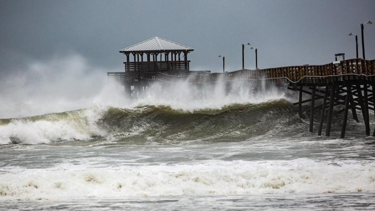 Waves slam the Oceanana Pier & Pier House Restaurant in Atlantic Beach, N.C., Thursday.
