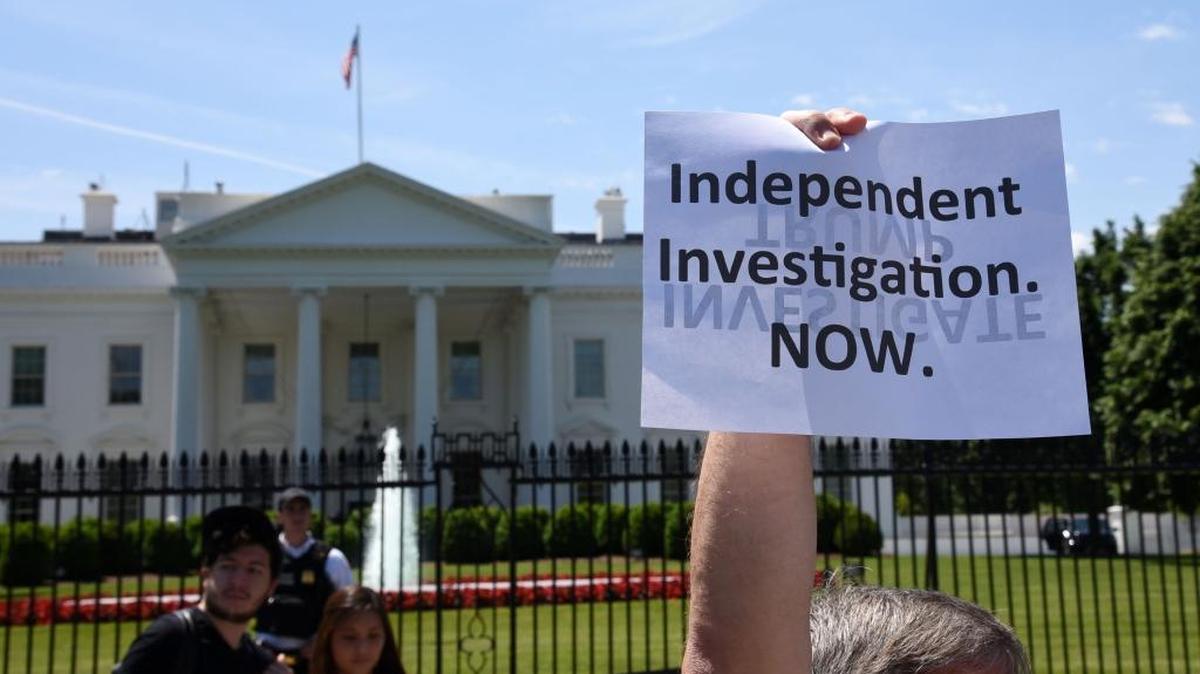 Protesters in front of the White House demand an investigation of President Donald Trump after he fired Jim Comey, director of the FBI, which was investigating the Trump campaign’s potential collusion with Russian efforts to sway the election.