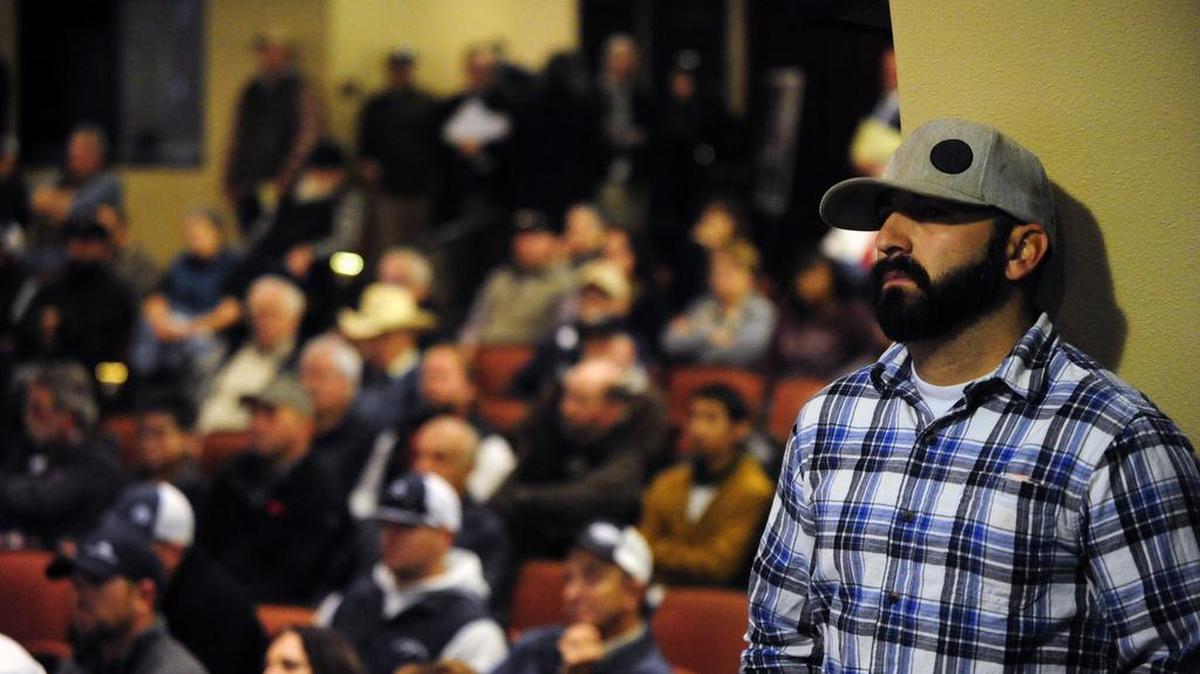 A farmer stands in the wings during a hearing conducted by the State Water Resources Control Board at the Merced Theatre in 2016. The board was supposed to vote on implementing its plan – which outraged residents of San Joaquin, Stanislaus and Merced counties – on Wednesday, but delayed it at the request of Gov. Jerry Brown and governor-elect Gavin Newsom.