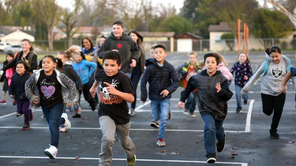 The Mighty Milers running group at Wilson Elementary School in Modesto run on Friday morning. The boy in the front is Xavier Townsend, who is in sixth grade. Also pictured are third-grader Arlene Rodriquez, left, and fourth-grader Kaden Guapo, right.