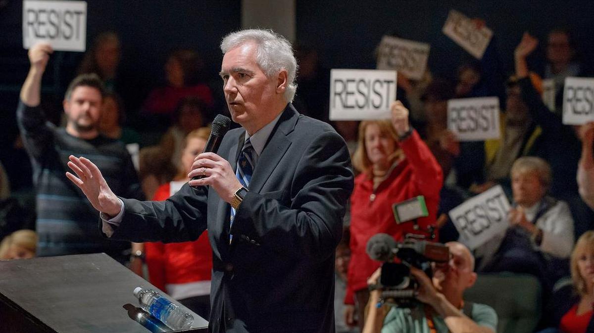 Rep. Tom McClintock, R-Elk Grove, fields questions Saturday in Roseville. McClintock faced a rowdy crowd at the packed meeting and was escorted out by police.