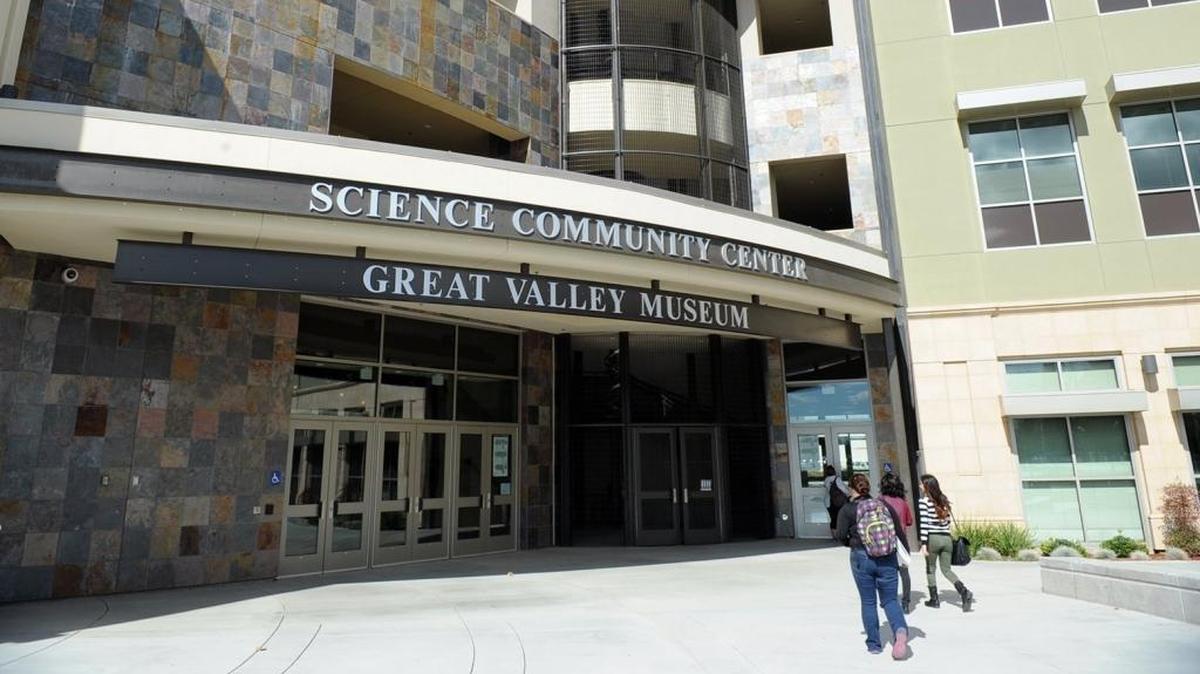 Students walk into the Science Community Center building at the Modesto Junior College West Campus.