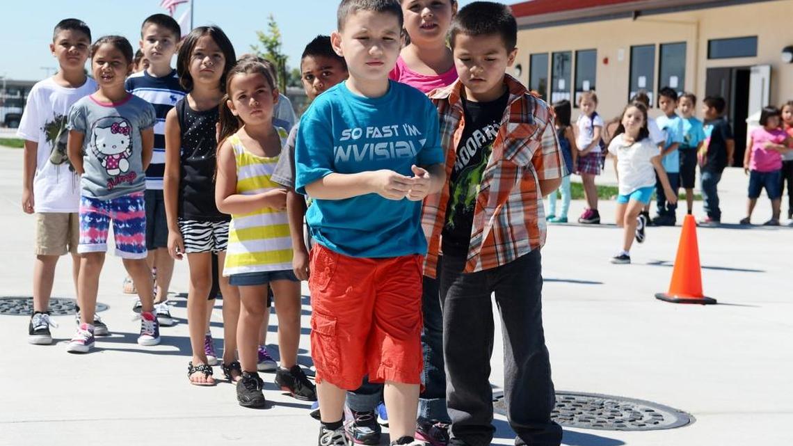 Students line up to enter a first-grade classroom at Lucas Elementary School in Ceres in 2013.