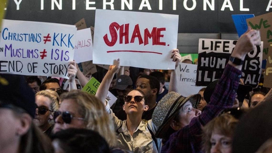 Demonstrators protest President Donald Trump’s immigration order on Sunday at Los Angeles International Airport.