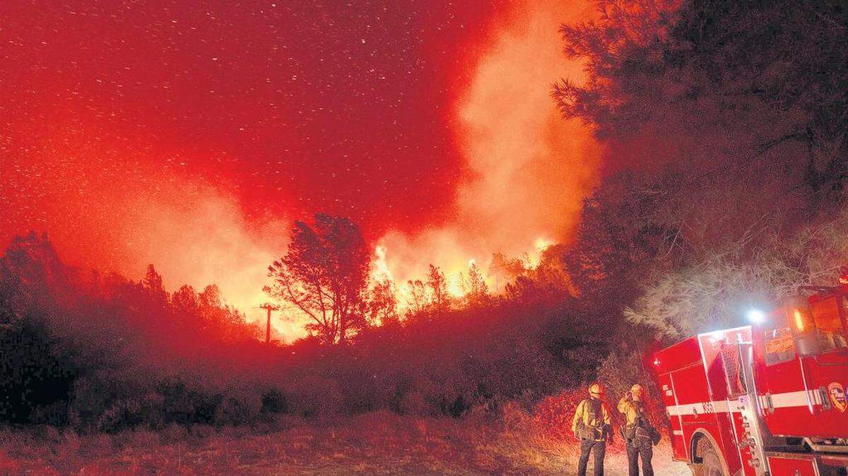 Firefighters watch the Bear Fire approach in Oroville, Calif., on Wednesday, Sept. 9, 2020. The blaze, part of the lightning-sparked North Complex, expanded at a critical rate of spread as winds buffeted the region. (AP Photo/Noah Berger)