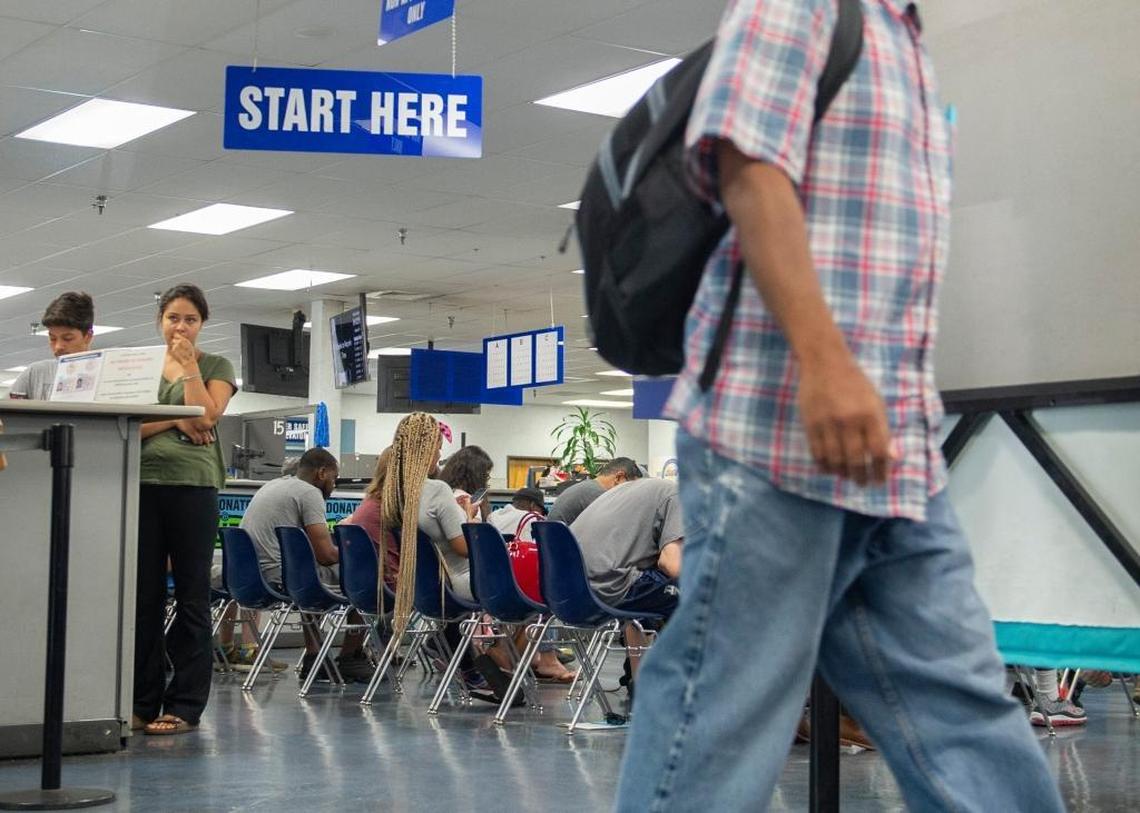 Sarah Sanchez, left, waits for her number to be called at the DMV in Sacramento, Thursday, June 14, 2018. The original numbering system has been replaced and a new system is being used in Sacramento.