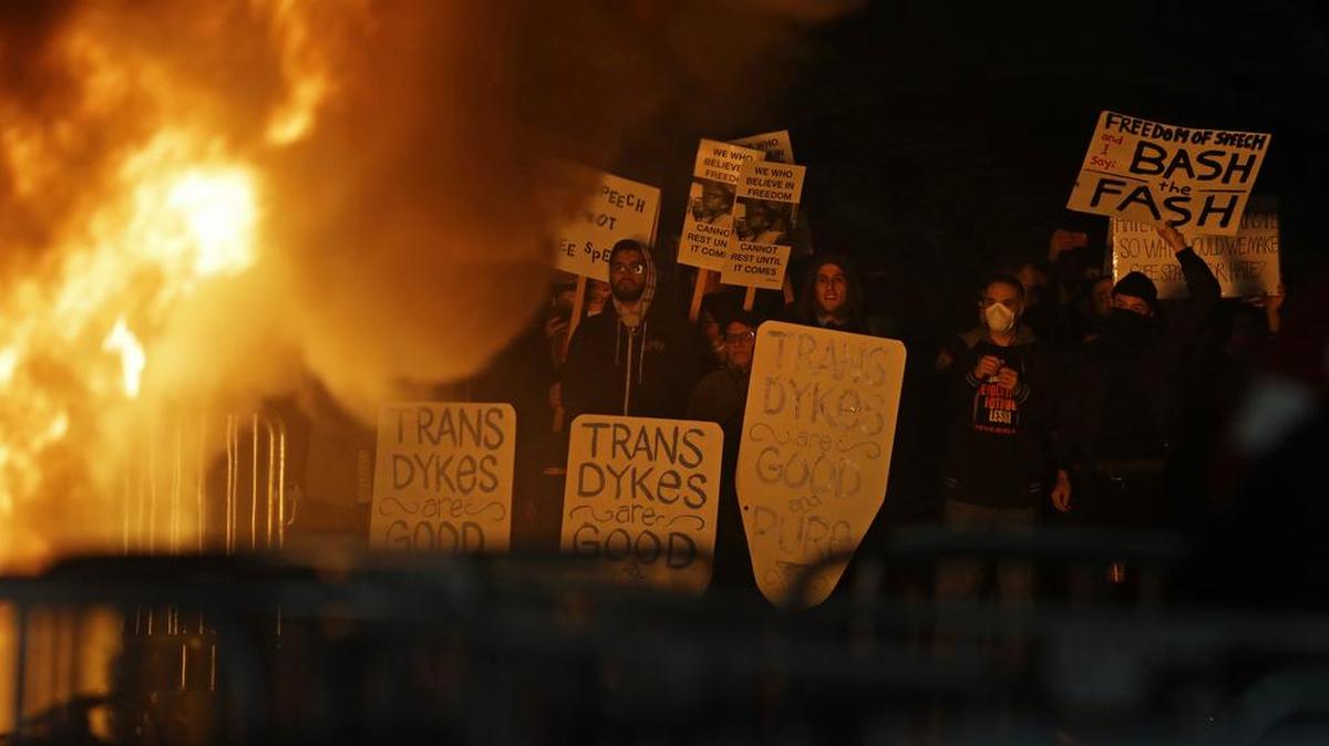Protesters watch a fire on Sproul Plaza at UC Berkeley during a rally against Breitbart News editor Milo Yiannopoulos, who had been scheduled to speak.