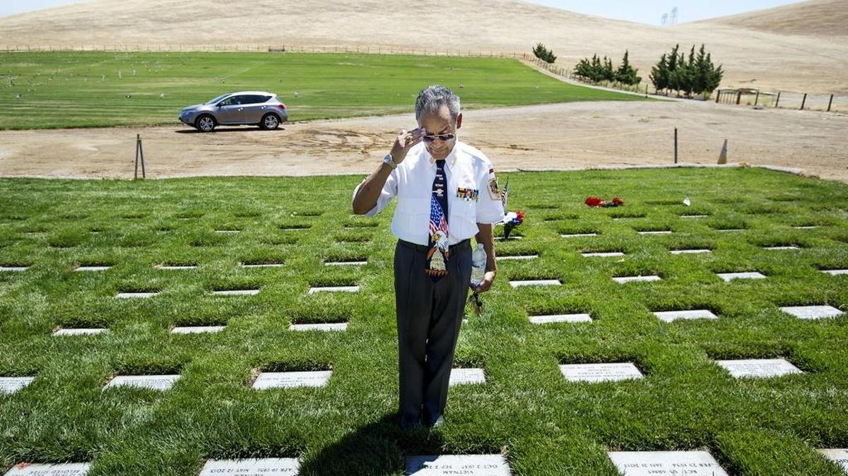 Navy veteran Pasquale Sobotka of Ceres salutes a fellow vet Richard Allan Sawyer during a Memorial Day ceremony at the San Joaquin Valley National Cemetery in 2014.