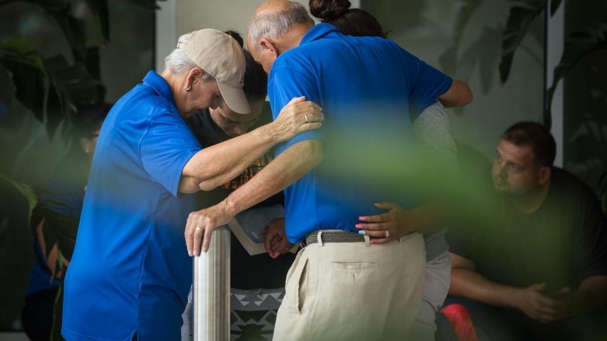 Relatives and friends of victims of the Orlando, Fla., nightclub shooting gather Sunday outside a Hampton Inn & Suites hotel near Orlando Regional Medical Center, where many victims have been treated.