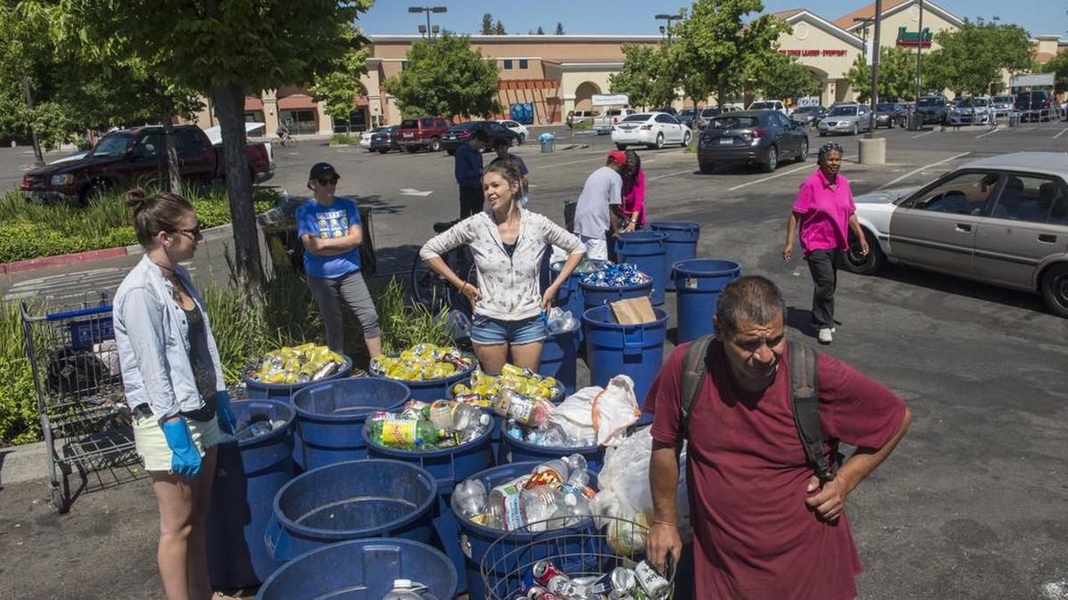 Consumers line up to cash in recyclables in June at RePlanet in North Sacramento, which is closing nearly 200 recycling centers across the state.