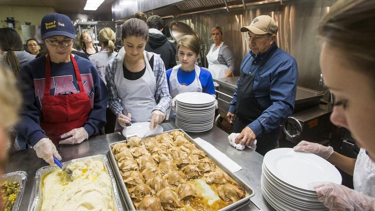 Dan Costa watches volunteers as they begin plating the annual Thanks-for-Giving feast at Modesto Centre Plaza in 2014. He and a dedicated group of volunteers feed nearly 1,000 people each year.