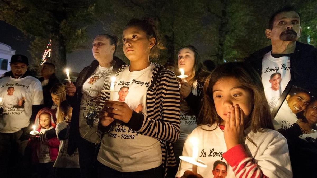 Kelly Vargas, left, pays tribute to her son, Frankie Vargas, with her nieces Annastasia Alvarez, 9, right, and Dasia Lee, 12, middle, and other members of Vargas family during the annual lighting of the homicide victims’ memorial tree and candlelight vigil outside the Stanislaus County Courthouse in Modesto in 2013. Frankie Vargas was killed in a drive-by shooting.