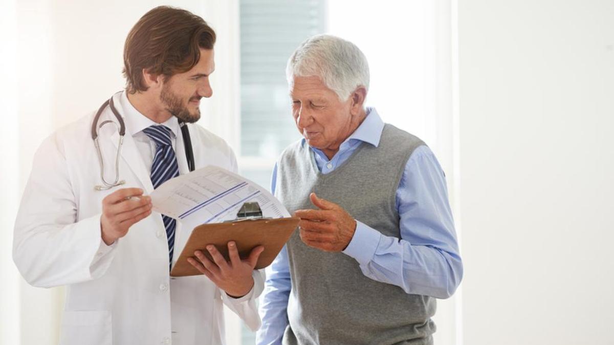 A doctor talks to a senior patient
