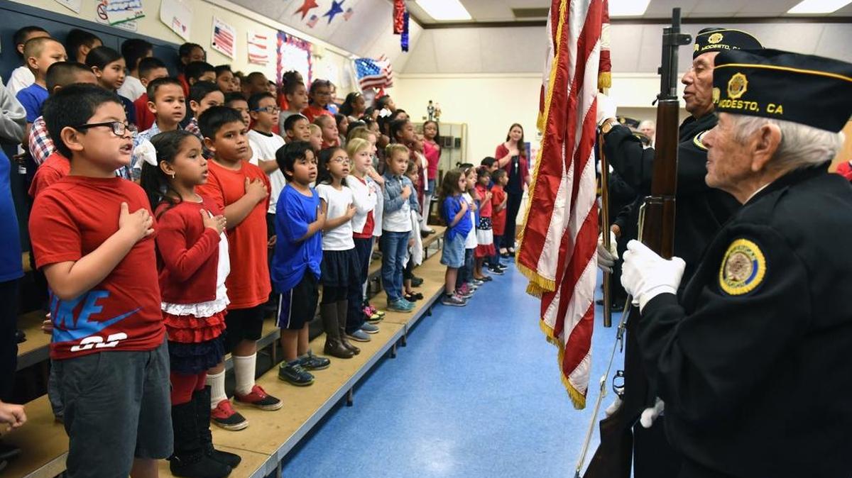 Students at Eisenhut Elementary in Modesto say the Pledge of Allegiance as members of the American Legion Post 74 presents the colors on Veterans Day in 2016.