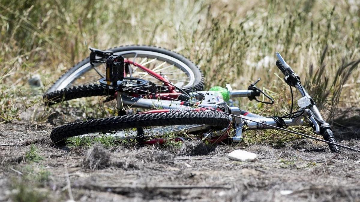 A bicycle lies on the ground at the scene of a crash in Atwater. The driver of a pick up truck drifted onto the shoulder of the road and struck an adult male rider.
