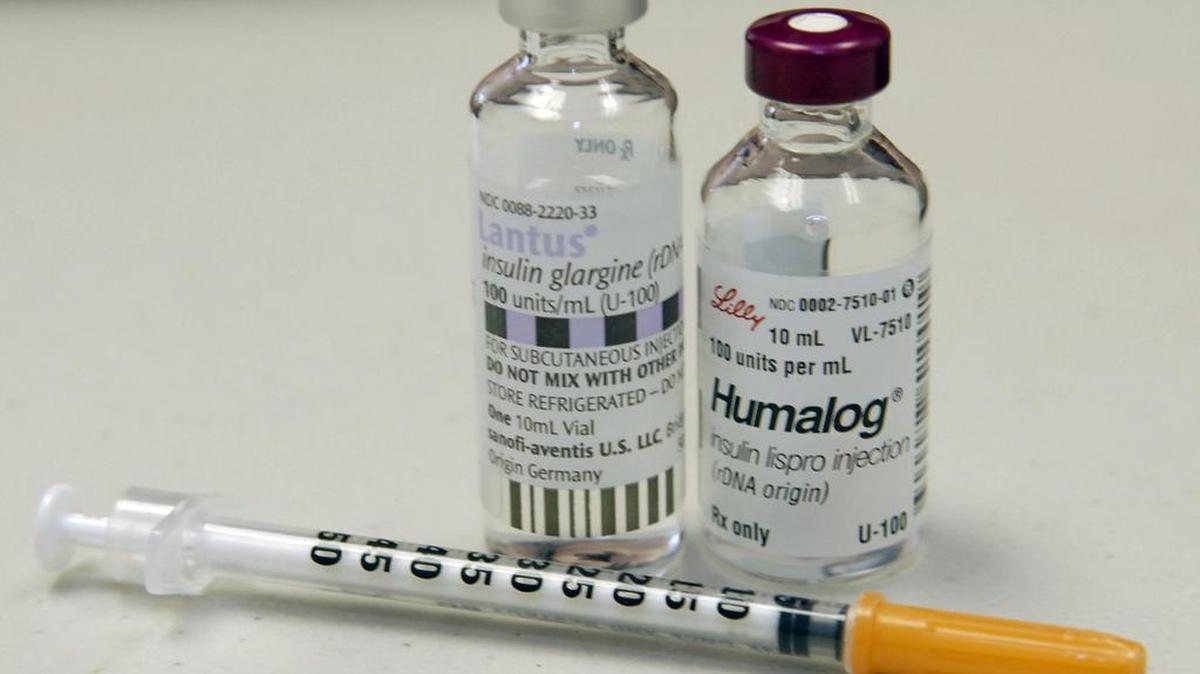 Insulin bottles and a syringe