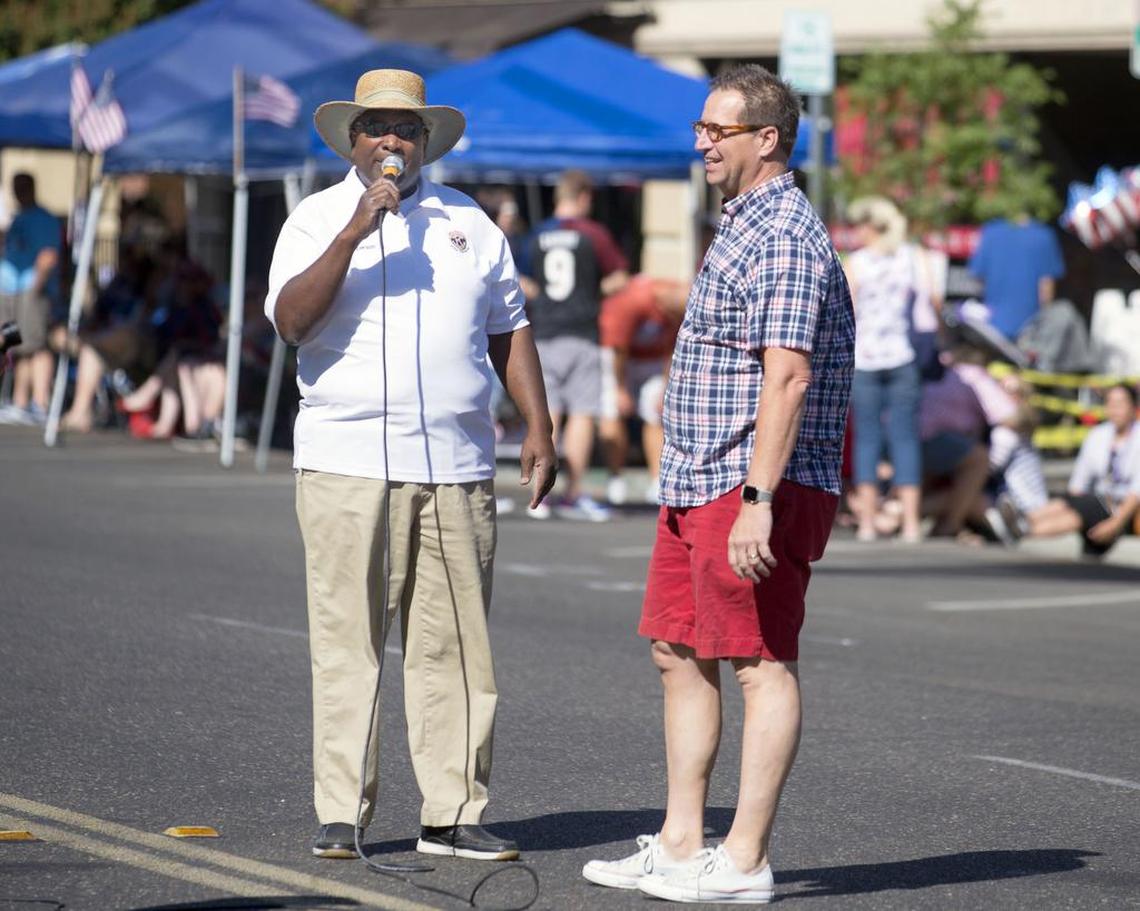 Parade Chairman Jeremiah Williams (left) and Chris Murphy talk to the crowd before the 145th annual Modesto Fourth of July Parade in Downtown Modesto on July 4, 2019.