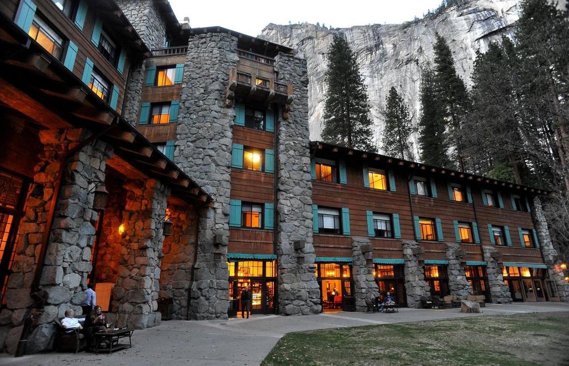The historic Ahwahnee Hotel lit up as dusk falls over Yosemite Valley.