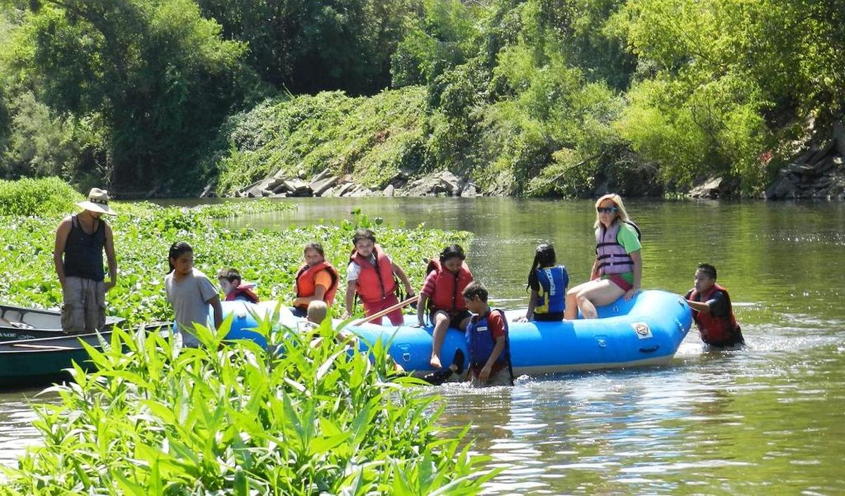 Kids raft with Meg Gonzalez of the Tuolumne River Trust during Family Summer Camp at the Tuolumne River Regional Park in Modesto. The Rec Fest is another opportunity to get to know the river.