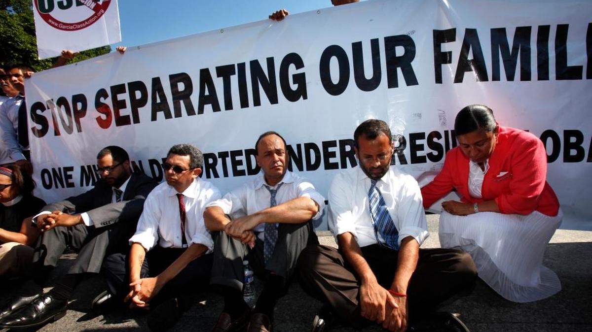 Supporters of the DREAM Act, including Rep. Luis Gutierrez, D-Ill., wait to be arrested during a rally in front of the White House in July.