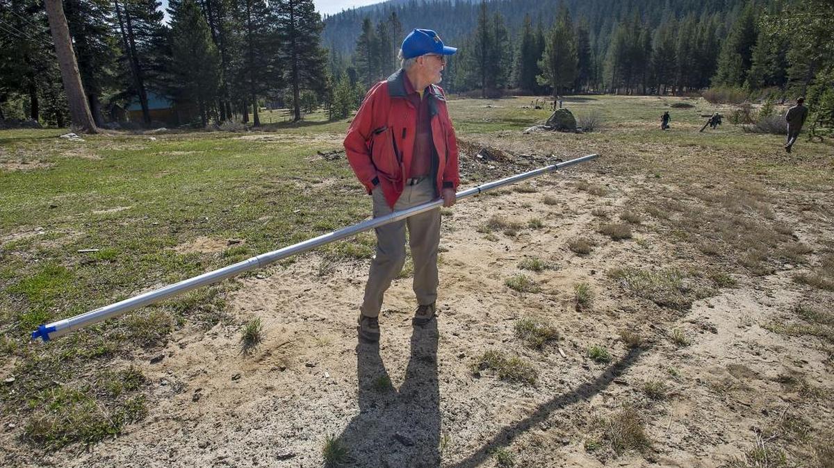 Frank Gehrke of the California Department of Water Resources looks over the futility of the measurement process during the annual snowpack survey in Phillips in 2015. This year’s snowpack was above normal. Such wild fluctuations – predicted yeras ago by climate scienticsts – are attributed to climate change.