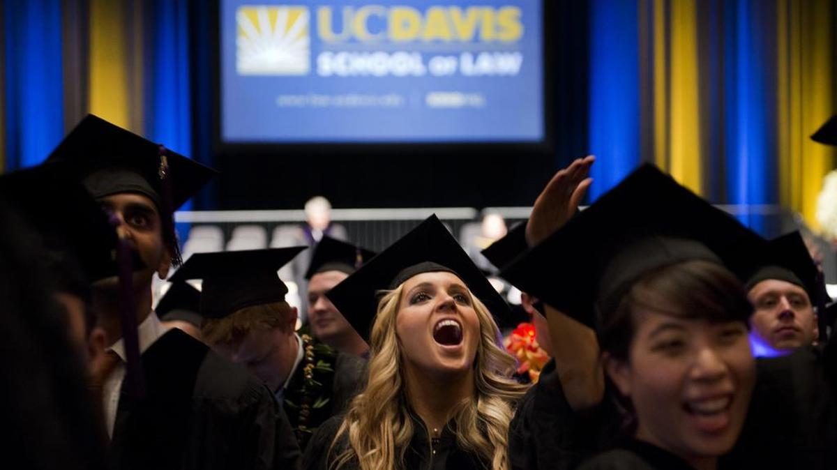 Graduates of the UC Davis law school celebrate after their 2013 commencement. The new Republican tax plan would not only punish states with high education spending, such as California, but also eliminate student loan interest deductions and tax tuition waivers that help many students afford graduate and professional schools.