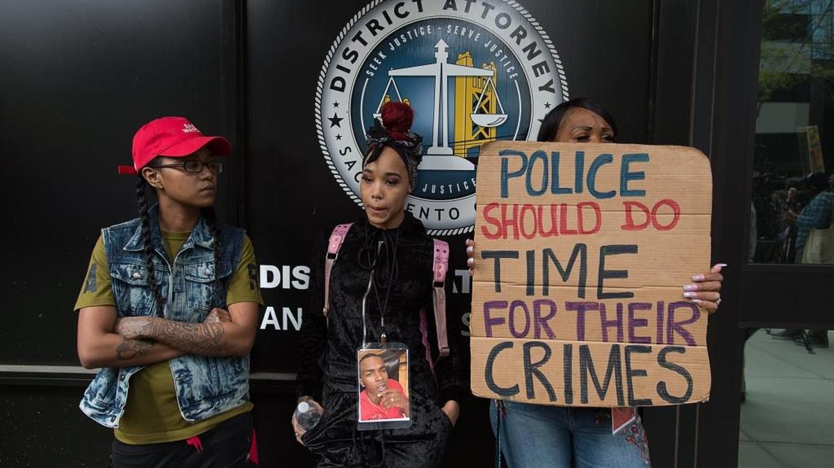 Protesters stand outside the Sacramento County District Attorney’s office expressing their anger over the killing of Stephon Clark.