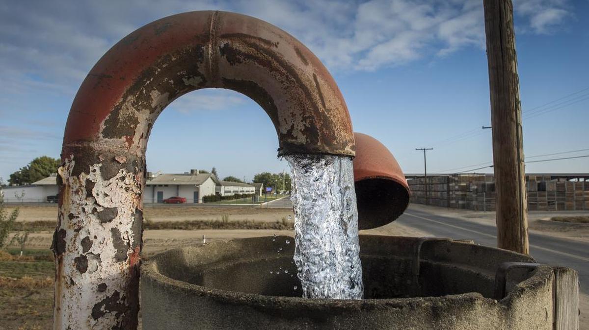 Water is pumped on a field in the Central Valley to irrigate food crops in nearby fields. Such pumping can affect neighbors, even cities, far from the pump if the subterranean groundwater aquifer is large enough.
