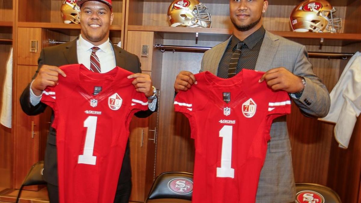 San Francisco 49ers first-round draft picks DeForest Buckner, right, and Joshua Garnett hold up jerseys during an NFL football news conference in Santa Clara, Calif., on Friday, April 29, 2016. Buckner was selected with the seventh overall pick; Garnett went 28th.