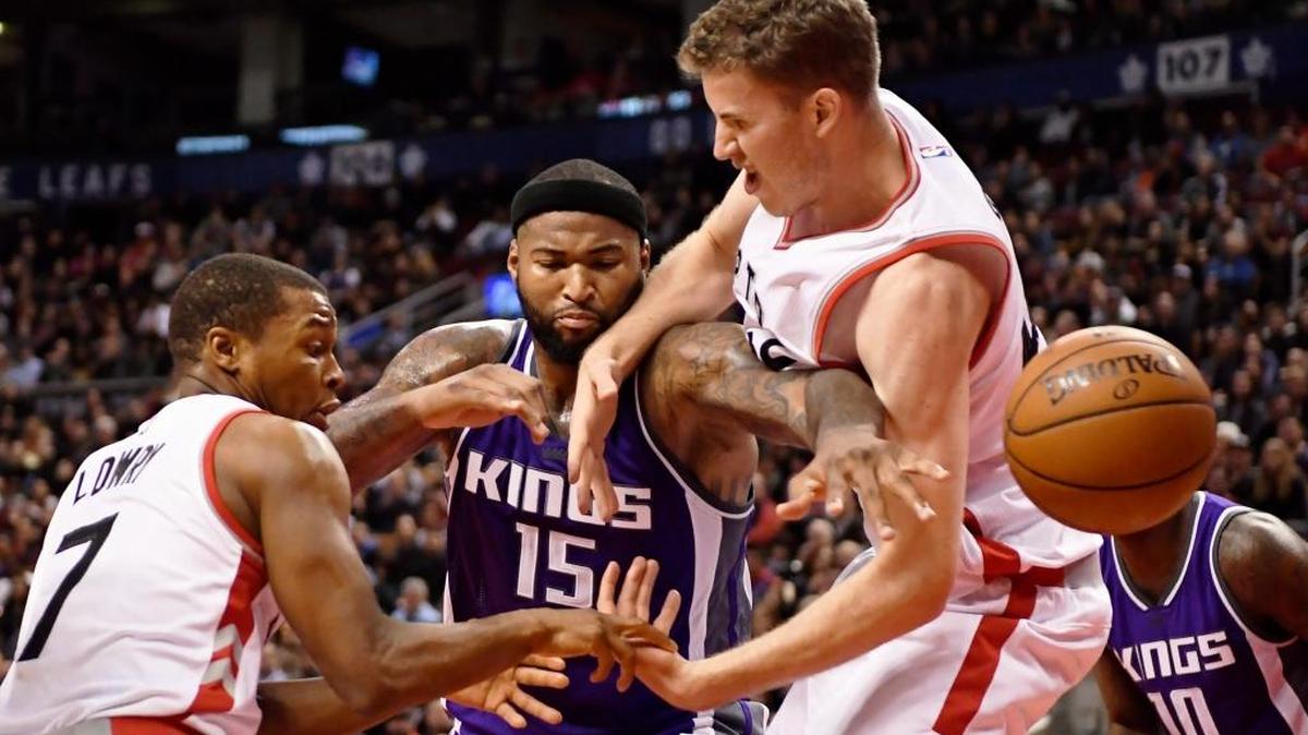 Kings center DeMarcus Cousins (15) battles for a loose ball with Toronto Raptors guard Kyle Lowry (7) and center Jakob Poeltl (42) during an NBA basketball game Sunday, Nov. 6, 2016 in Toronto. The Kings broke a four-game losing streak and salvaged a five-game trip with a 96-91 victory.