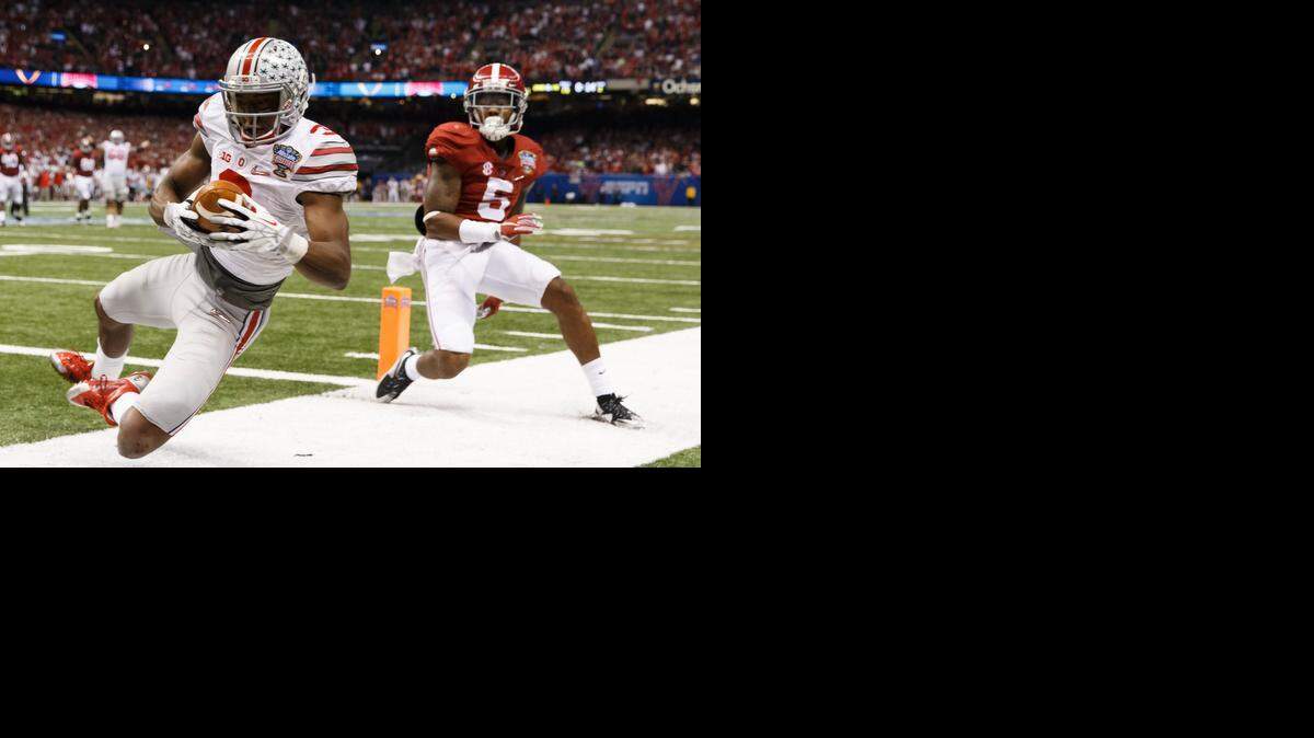 Ohio State’s Michael Thomas catches a 13-yard touchdown pass  from fellow wideout  Evan Spencer as Alabama’s Cyrus Jones defends in the second quarter.