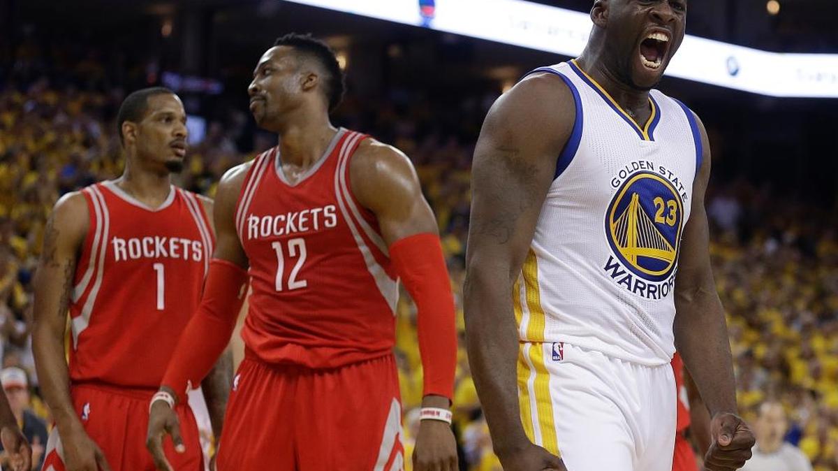 The Golden State Warriors’ Draymond Green, right, reacts after being fouled by the Houston Rockets’ Dwight Howard (12) during Game 2 of a first-round NBA basketball playoff series Monday, April 18, 2016, in Oakland. At left is the Rockets’ Trevor Ariza (1).