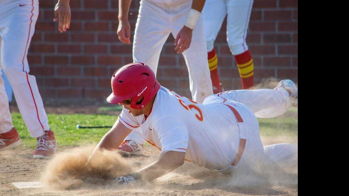 
 Oakdale senior Nolen Legan slides into home plate Friday (04-24-15) in Oakdale, Calif. with the winning run as the Mustangs scored two runs in the bottom of the seventh for a dramatic, 4-3 walk-off victory over Sierra that leaves the teams tied for first in the Valley Oak League with four games remaining.

