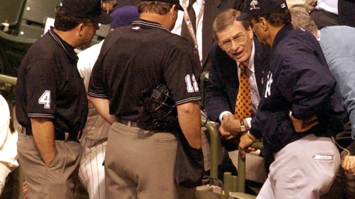 Then Baseball Commissioner Bud Selig huddles with American League manager Joe Torre, right, and National League manager Bob Brenly and the umpires as they decide to call the 2002 All-Star Game a 7-7 tie after both teams ran out of pitchers after 11 innings.