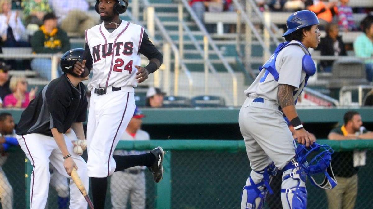 Nut's outfielder Wes Rogers (24) crosses home plate to score a run during a Modesto Nuts game against the Stockton Ports at John Thurman Field in Modesto California on April 29, 2016.