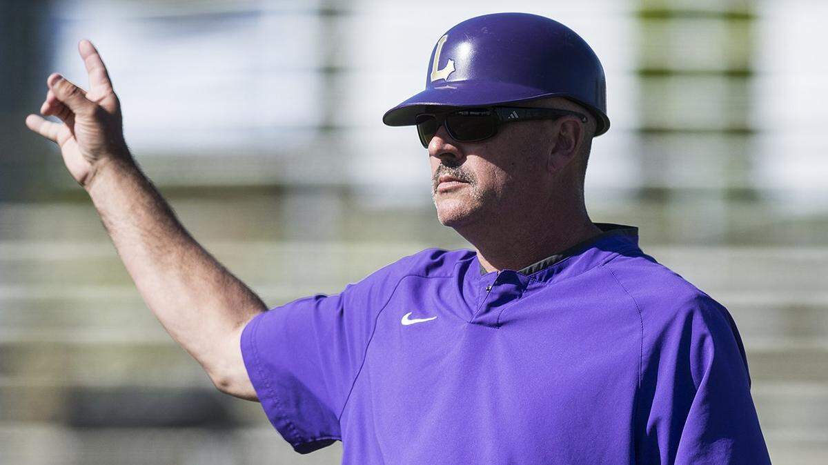Livingston head coach Matt Winton reminds his base runners there are two outs during a game against Mountain House at Memorial Park in Atwater, Calif., on Thursday, April 20, 2017. The Mustangs beat the Wolves 5-0.