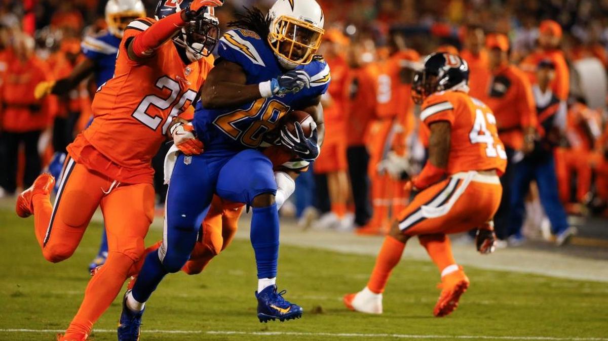 San Diego Chargers running back Melvin Gordon is brought down by Denver Broncos free safety Darian Stewart, left, and cornerback Chris Harris during the second half of an NFL football game Thursday, Oct. 13, 2016, in San Diego. Gordon rushed for 94 yards on 27 carries.