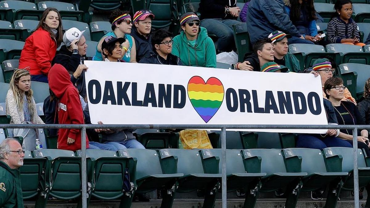 Pride Night had a somber feel in Oakland. Here fans display a banner in memory of those who were killed Sunday in Orlando, Fla.