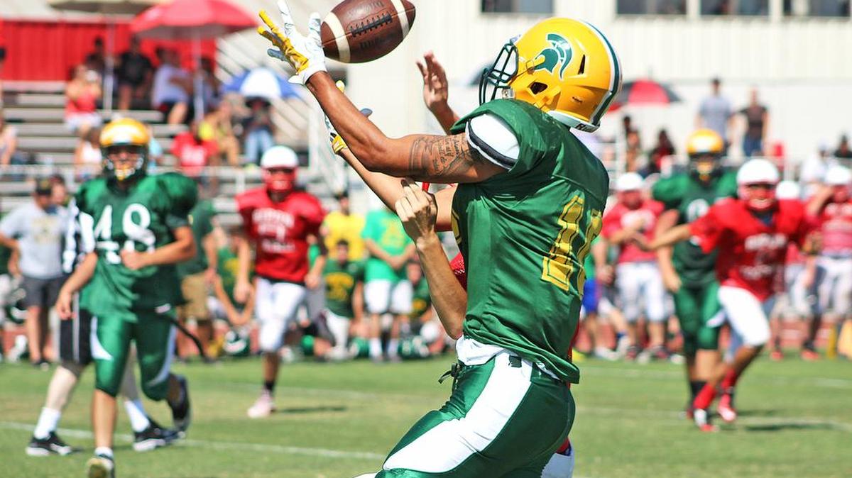 
Davis’ Talolo Limu-Jones makes a juggling catch during a scrimmage Saturday in Ripon. Limu-Jones’ coach, Tim Garcia, will represent the school at today’s Modesto Quarterback Club meeting. 
