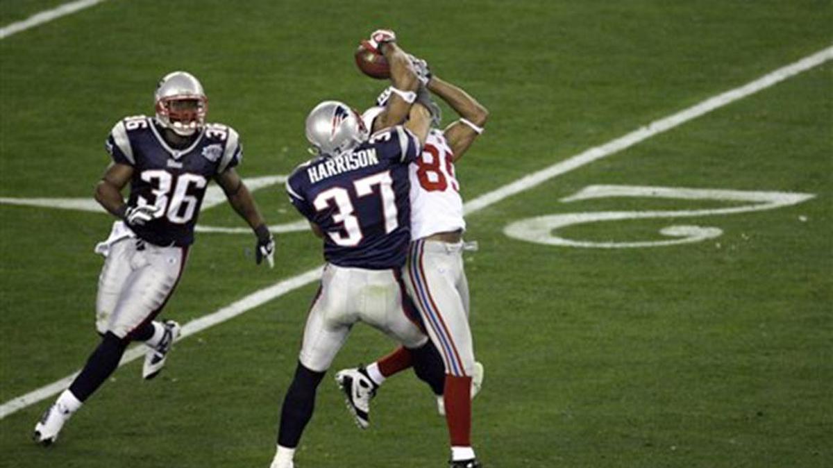 New York Giants David Tyree (85) makes a circus catch the New England Patriots’ Rodney Harrison defends during the Super Bowl XLII football game at University of Phoenix Stadium on Sunday, Feb. 3, 2008 in Glendale, Ariz. Eli Manning escaped pressure on the play and completed the 32-yard miracle pass to set up the Giants winning touchdown.