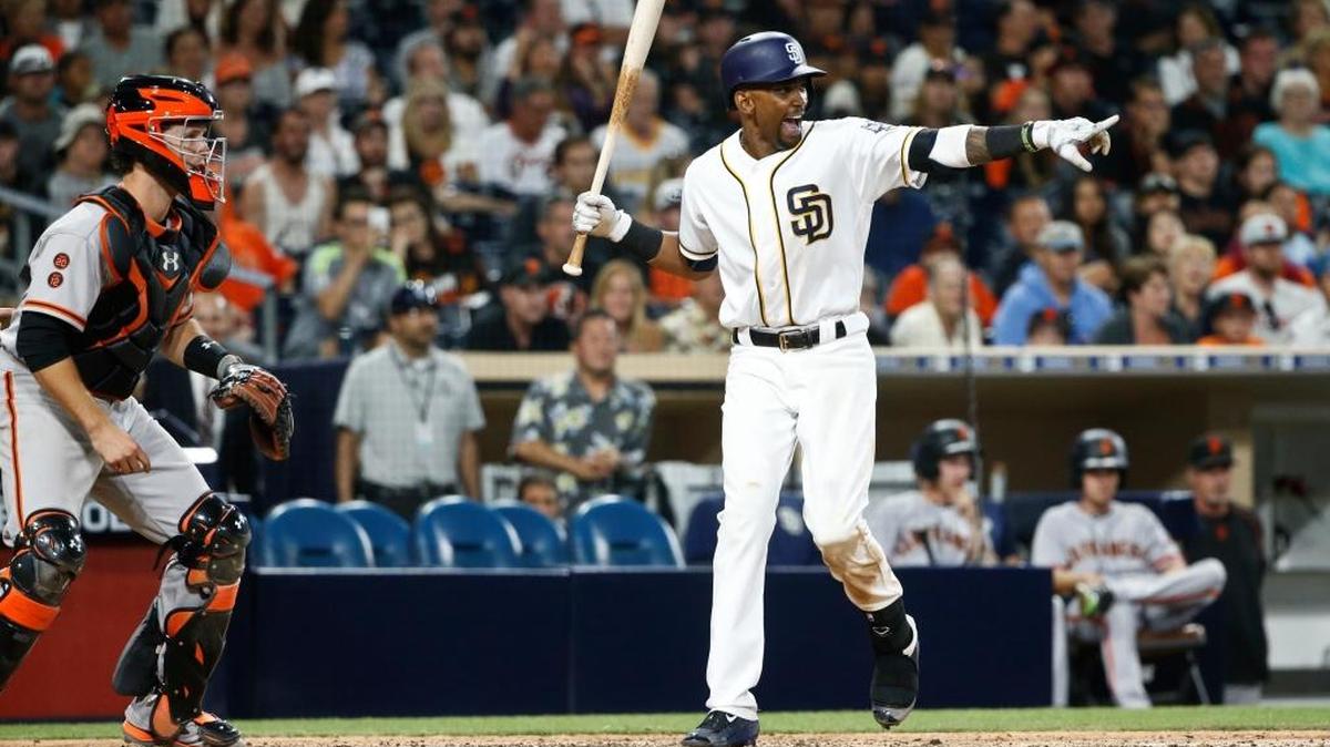 Giants catcher Buster Posey looks on as San Diego’s Alexei Ramirez points at closer Santiago Casilla, who committed a balk during Ramirez’s at-bat in the 10th inning Saturday that brought home the winning run.